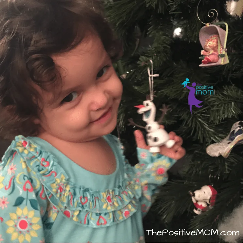 Little Pige loves her new Olaf ornament - she wants to play with him!