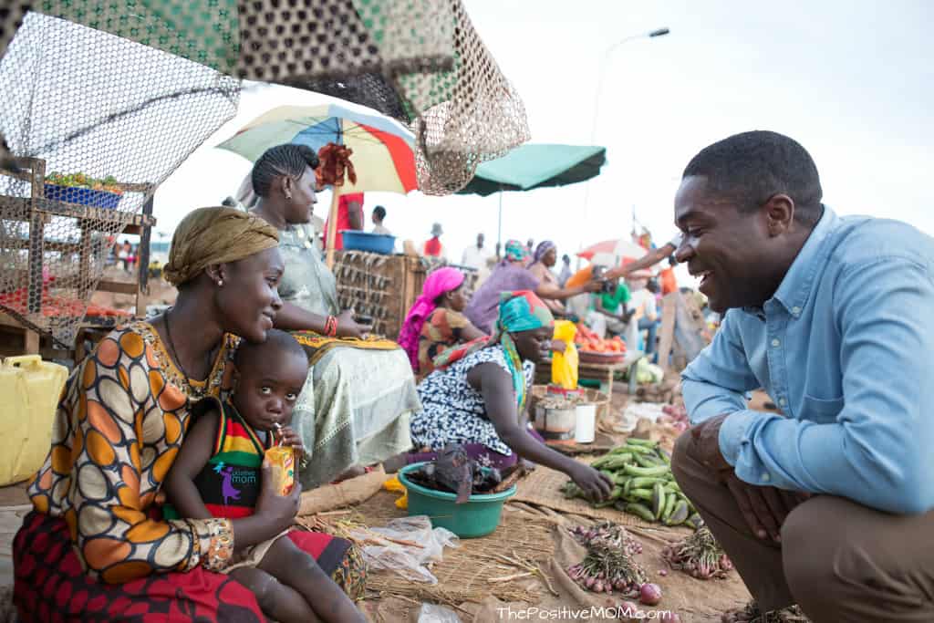 Queen Of Katwe - Harriet selling vegetables at the Ugandan market with baby Richard and Coach Katende