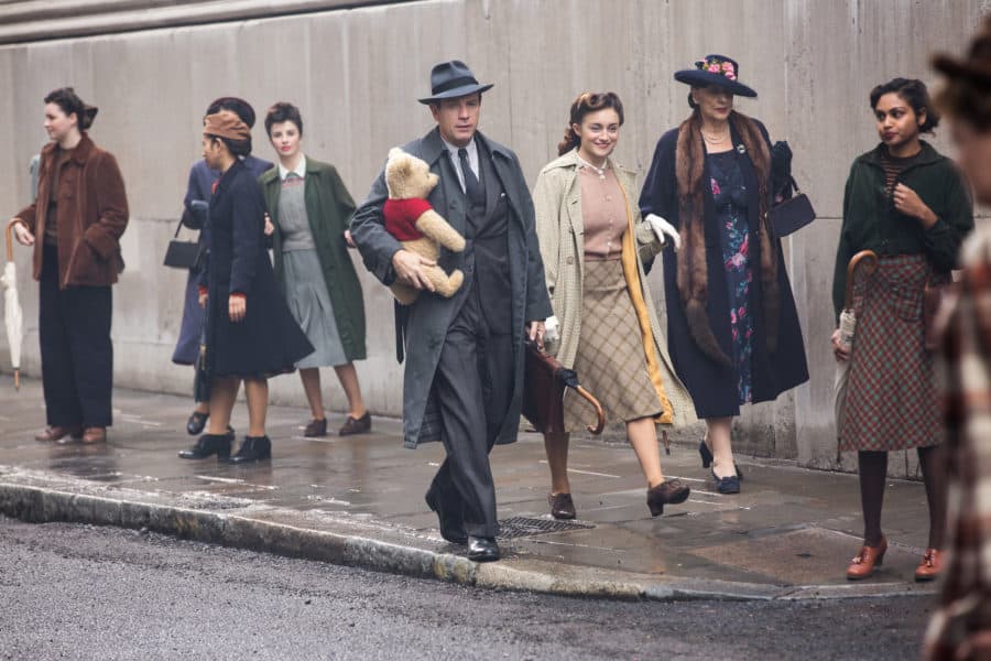 Christopher Robin (Ewan McGregor) and his longtime friend Winnie the Pooh walk down the street in London in Disney’s CHRISTOPHER ROBIN.