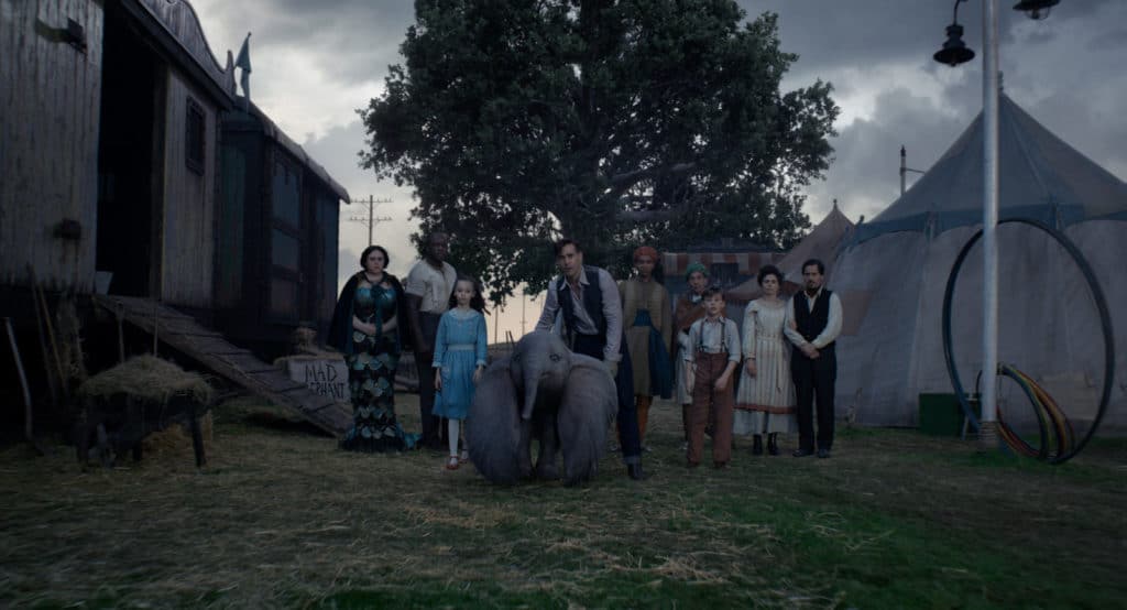 FAMILY TIES – In Tim Burton’s all-new, live-action reimagining of “Dumbo,” Holt Farrier (Colin Farrell), with the help of his children Milly (Nico Parker) and Joe (Finley Hobbins), is called on to take care of a newborn elephant whose oversized ears make him a laughingstock in an already struggling circus. Holt’s circus family includes Miss Atlantis (Sharon Rooney), Rongo (DeObia Oparei), Pramesh’s nephew (Ragevan Vasan), Pramesh Singh (Roshan Seth), Catherine the Greater (Zenaida Alcalde) and Ivan the Wonderful (Miguel Muñoz). “Dumbo” opens in theaters on March 29, 2019. © 2018 Disney Enterprises, Inc. All Rights Reserved.