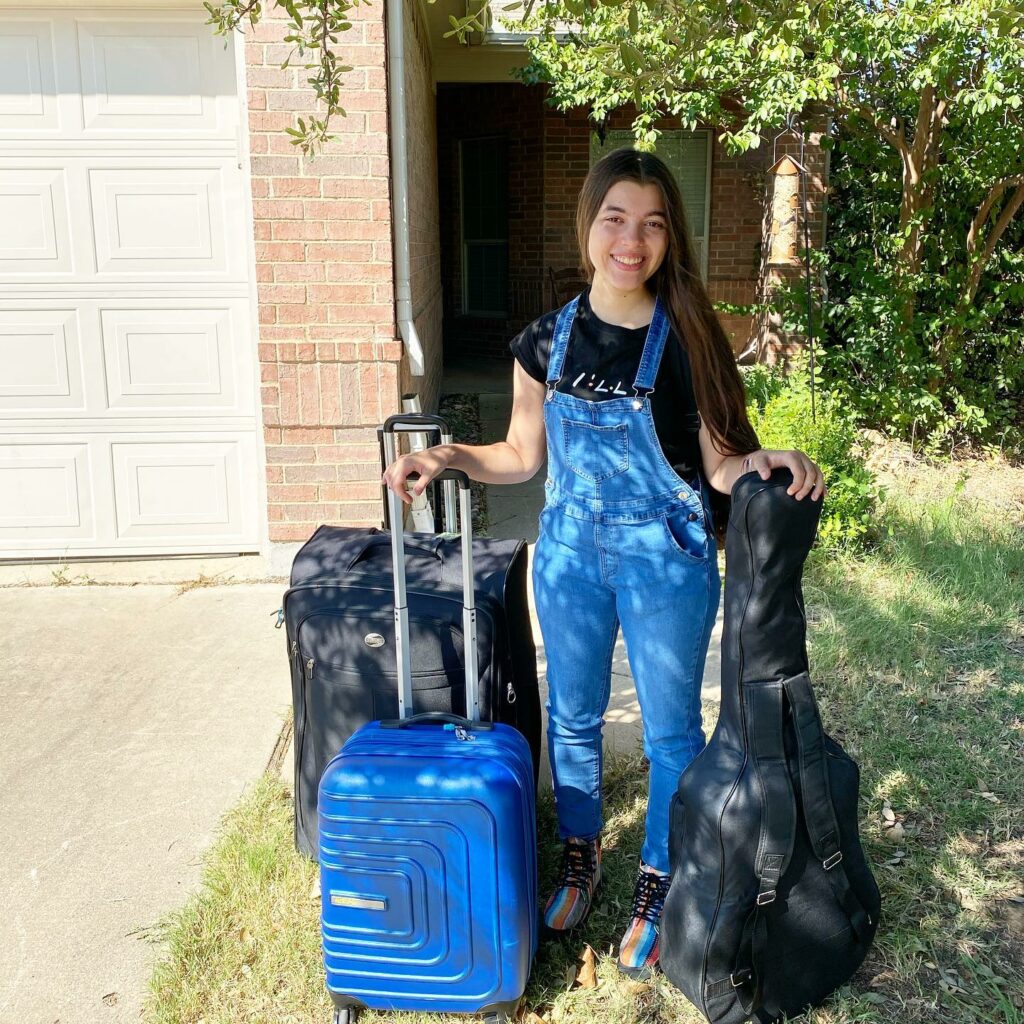 Daughter with suitcases college-bound